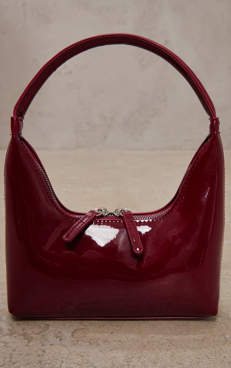 https://cdn-img.prettylittlething.com/d/5/5/7/d557645b1c20eaf8d6143426d3f3f77a055bc12e_CNH0025_3_burgundy_patent_simple_structured_double_zip_shoulder_bag.jpg