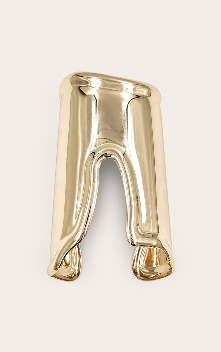https://cdn-img.prettylittlething.com/d/c/5/0/dc50b0df5ccd2bc62b1273e9fe562d38414f1287_CNN1132_2_gold_smooth_asymmetric_cuff.jpg