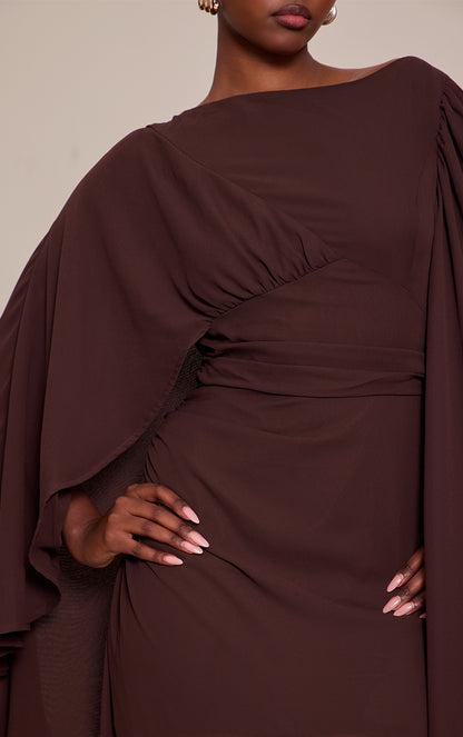 https://cdn-img.prettylittlething.com/1/5/c/8/15c8ee091e9141457605540d32cce3473910f7ba_CNP0922_4_chocolate_chiffon_cape_detail_maxi_dress.jpg
