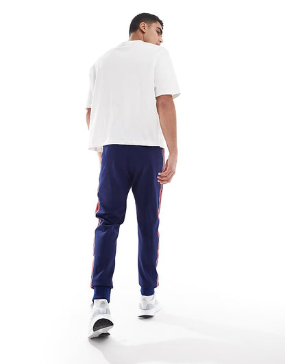 https://images.asos-media.com/products/adidas-football-arsenal-icons-trackpants-in-navy-and-red/207197386-4?$n_750w$&wid=750&fit=constrain