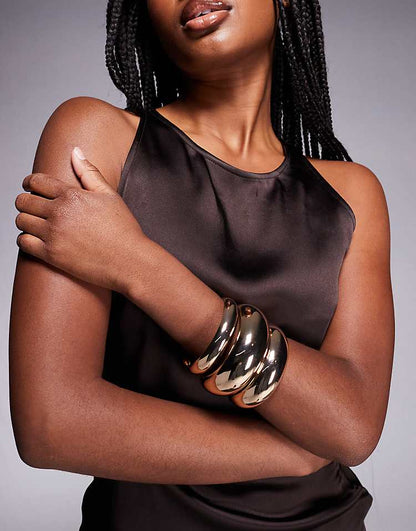 https://images.asos-media.com/products/aldo-bena-pack-of-3-chunky-bangle-bracelets-in-gold/208421723-1-gold?$n_750w$&wid=750&fit=constrain
