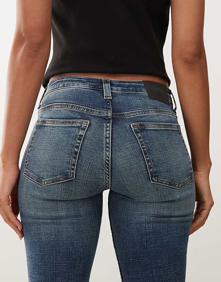 https://images.asos-media.com/products/weekday-katsumi-low-waist-flared-jeans-in-dark-blue-wash/209080664-5?$n_750w$&wid=750&fit=constrain