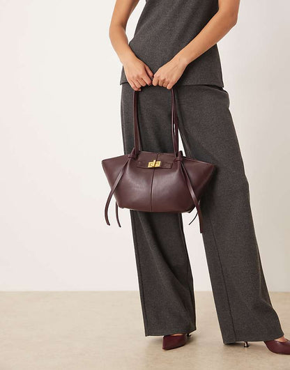 https://images.asos-media.com/products/gina-tricot-faux-leather-small-tote-bag-with-strap-and-clutch-detail-in-dark-red-burgundy/209114651-2?$n_750w$&wid=750&fit=constrain