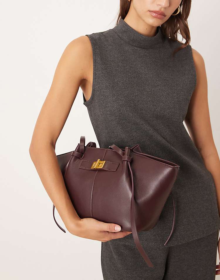 https://images.asos-media.com/products/gina-tricot-faux-leather-small-tote-bag-with-strap-and-clutch-detail-in-dark-red-burgundy/209114651-3?$n_750w$&wid=750&fit=constrain