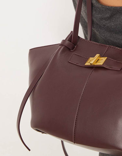 https://images.asos-media.com/products/gina-tricot-faux-leather-small-tote-bag-with-strap-and-clutch-detail-in-dark-red-burgundy/209114651-4?$n_750w$&wid=750&fit=constrain