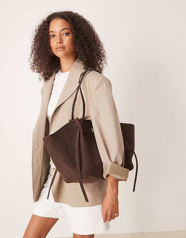 https://images.asos-media.com/products/gina-tricot-faux-suede-medium-tote-bag-with-strap-and-clutch-detail-in-dark-brown/209114717-2?$n_750w$&wid=750&fit=constrain