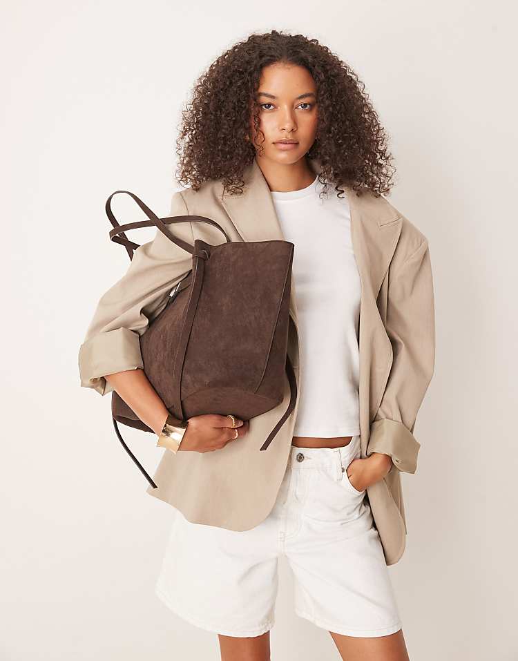 https://images.asos-media.com/products/gina-tricot-faux-suede-medium-tote-bag-with-strap-and-clutch-detail-in-dark-brown/209114717-4?$n_750w$&wid=750&fit=constrain