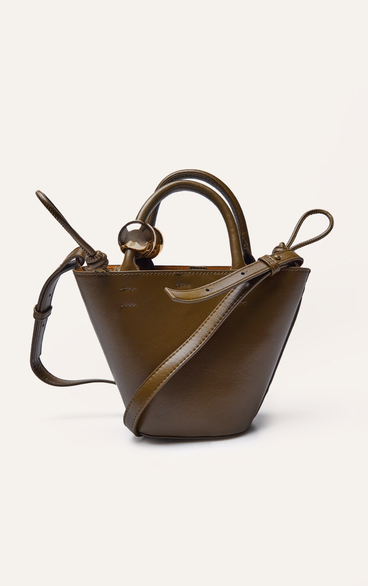 https://cdn-img.prettylittlething.com/2/6/f/4/26f4f2398b9ea63143b80f6995bc9f4759523b61_CNO0735_4_olive_bead_handle_bucket_cross_body_bag.jpg