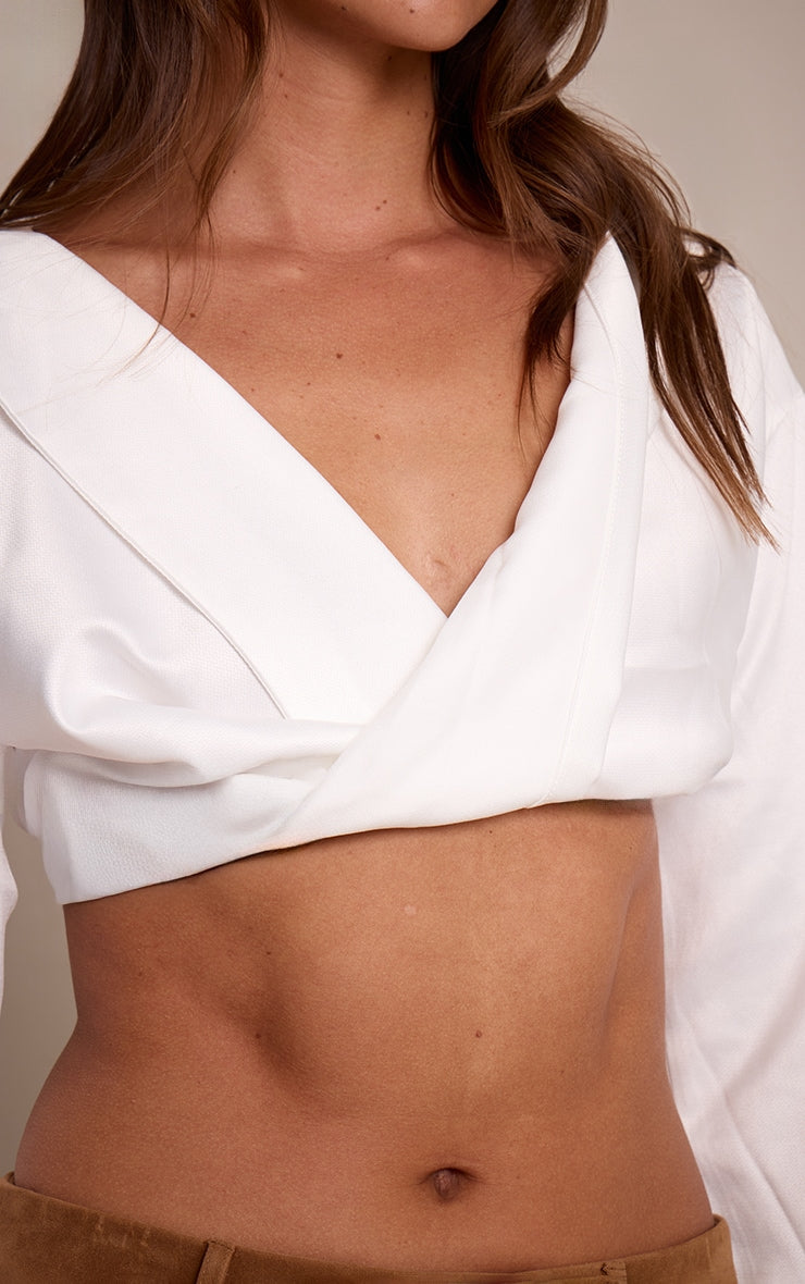 https://cdn-img.prettylittlething.com/2/d/7/2/2d72cecdd1f2cb5fdc1648d5bfea7d987352945c_CLZ9595_4_white_satin_bardot_twist_front_crop_blouse.jpg