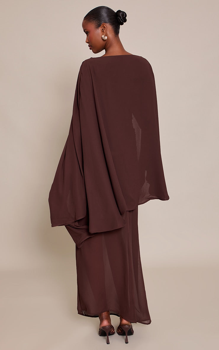 https://cdn-img.prettylittlething.com/6/d/c/5/6dc5791fca85eb3b02b8653362363156d6c929e6_CNP0922_2_chocolate_chiffon_cape_detail_maxi_dress.jpg