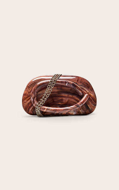 https://cdn-img.prettylittlething.com/6/e/b/9/6eb9bcd8a2e17808a45ed0e22cfb8f2e0eeffa8e_CNO2875_3_chocolate_marble_hard_resin_clutch_bag.jpg