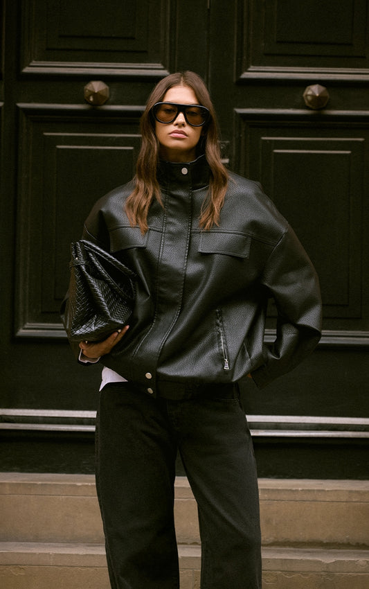 https://cdn-img.prettylittlething.com/7/f/7/8/7f782dd6f6c036a898f0320d876f959c90aca80d_CNO0273_1_black_funnel_neck_concealed_placket_faux_leather_jacket.jpg
