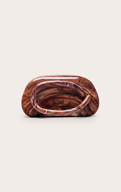 https://cdn-img.prettylittlething.com/9/f/8/5/9f854d5061c71de4055a7474dab733df557d00dd_CNO2875_2_chocolate_marble_hard_resin_clutch_bag.jpg