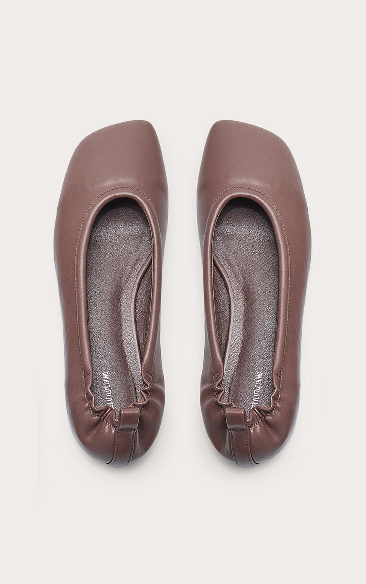https://cdn-img.prettylittlething.com/b/8/c/a/b8caeb909da1c720c9d50794bce78315c5f97c99_CNN0446_5_chocolate_pu_asymmetric_square_toe_ballet_pump.jpg