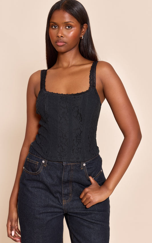 https://cdn-img.prettylittlething.com/d/1/2/b/d12b6cc54a4fbdda9ca7c83035087536500f95e7_CNO0756_1_black_lace_detail_strappy_cropped_corset_top.jpg